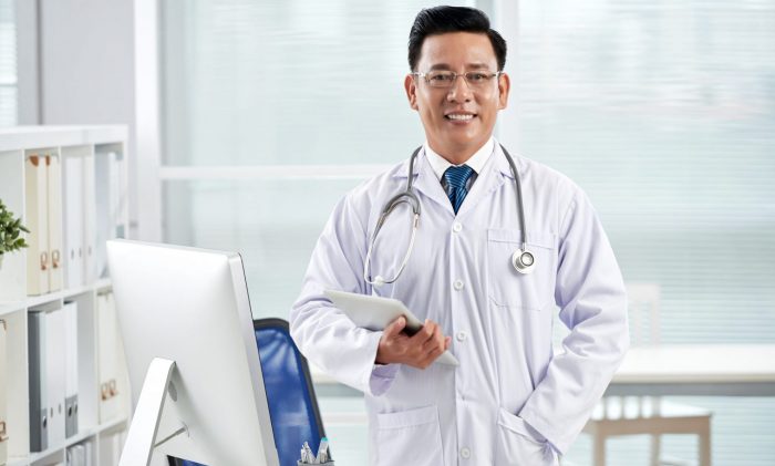 Photo of doctor in his office illustrates blog: "7 Essential Terms To Understand Medical Legal Billing in California"