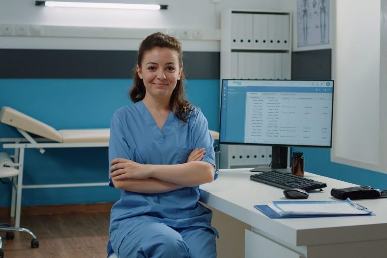 Photo of woman in scrubs in doctor's office illustrates blog: "Medical Billing: Electronic Claims Facts You Need to Know"