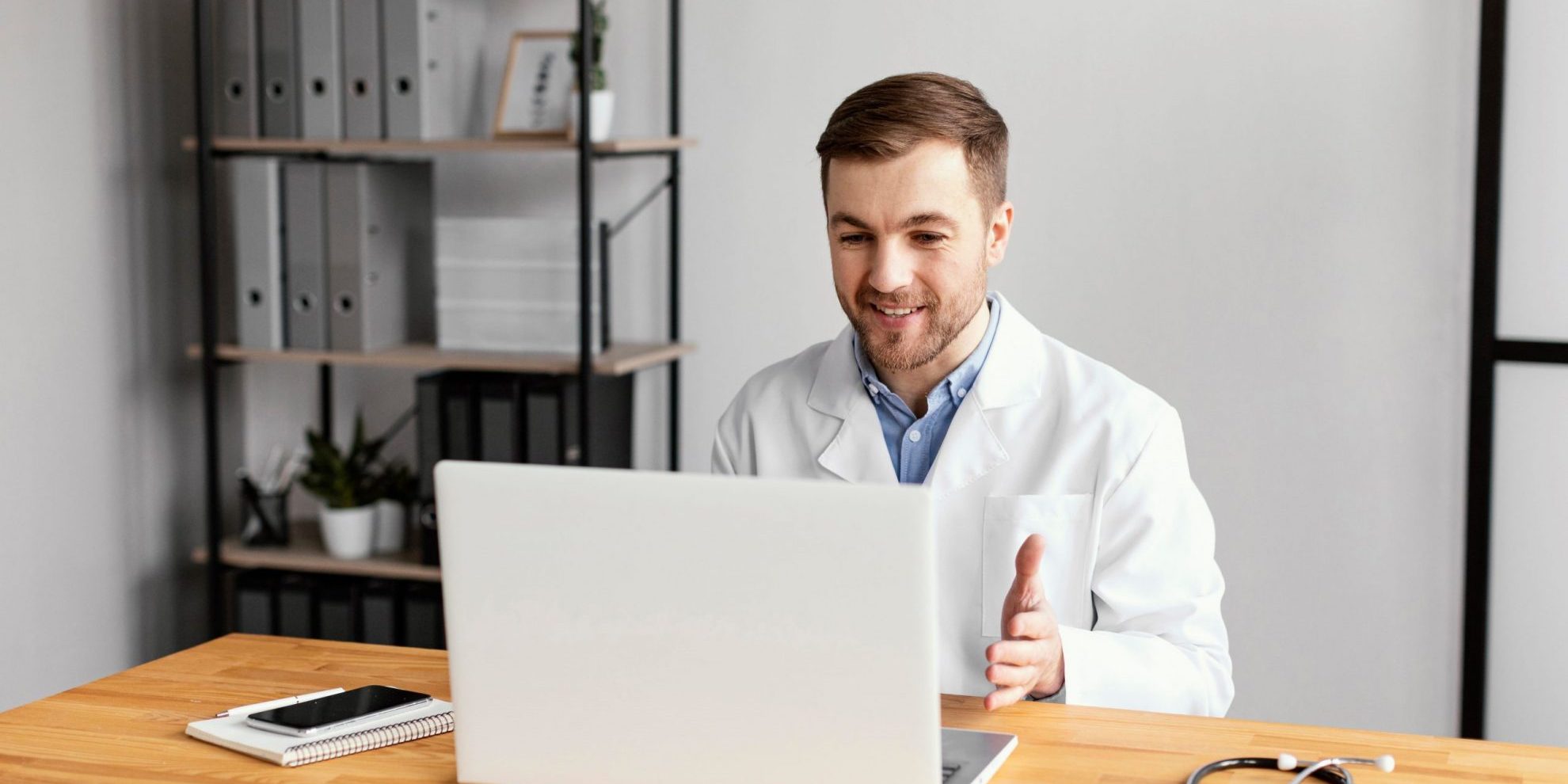 Photo of doctor in video meeting illustrates blog: "The DWC Intends to Extend Emergency Regulations for Medical-Legal Evaluations"