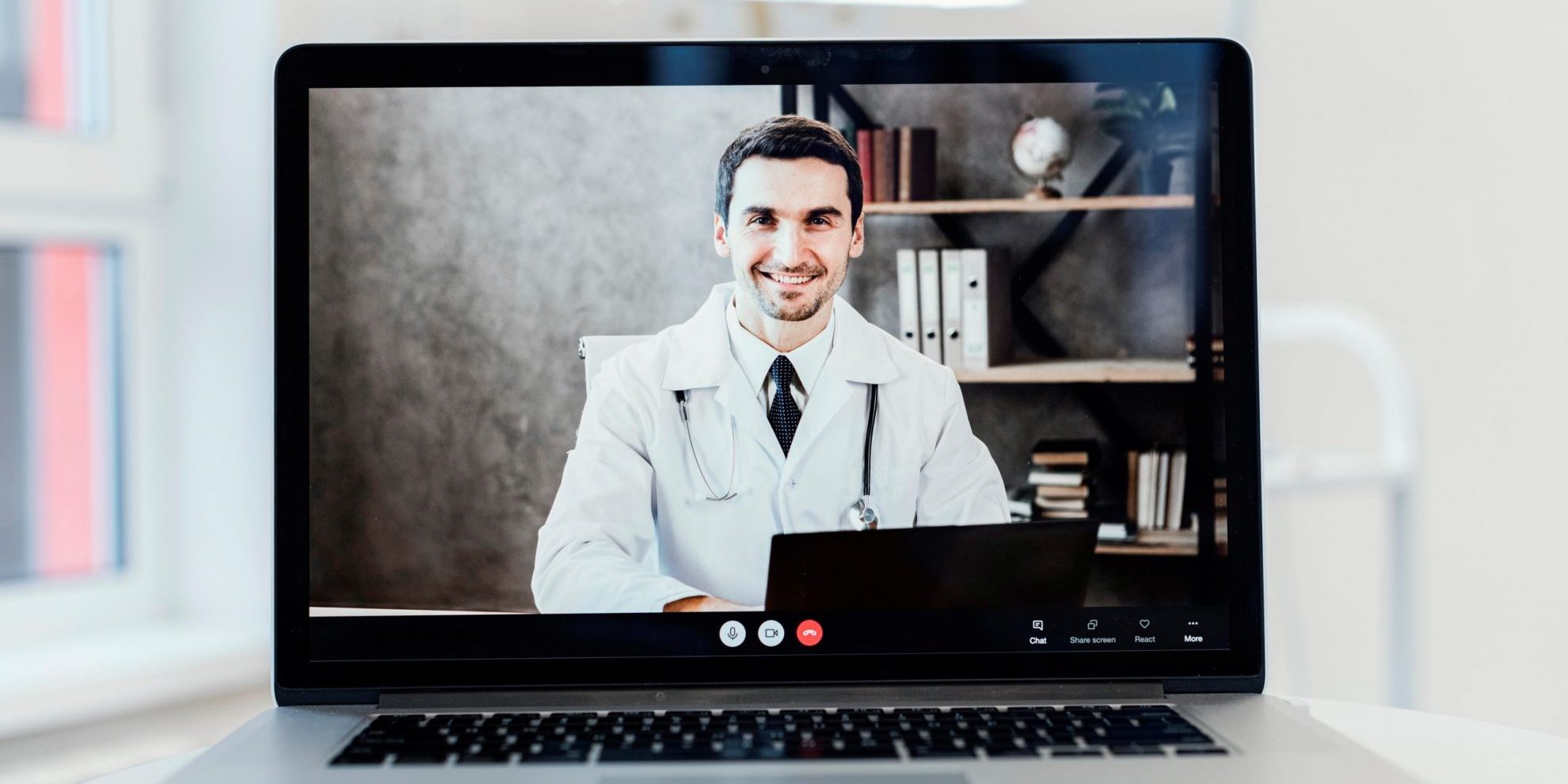 Photo of doctor on laptop screen illustrates blog: "It’s Official: the DWC Extends Emergency Regulations for Medical-Legal Evaluations"