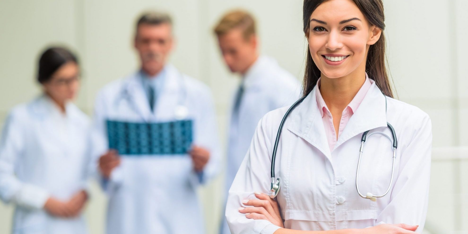 Photo of smiling female doctor illustrates blog: "Medical Legal Billing: What Is the Difference Between a QME and an AME?"