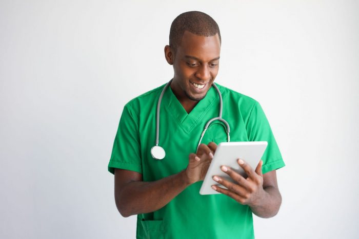 Photo of doctor looking at tablet illustrates blog: "California Emergency Regulations for Medical Legal Evaluations To Remain in Place Through January 2023"