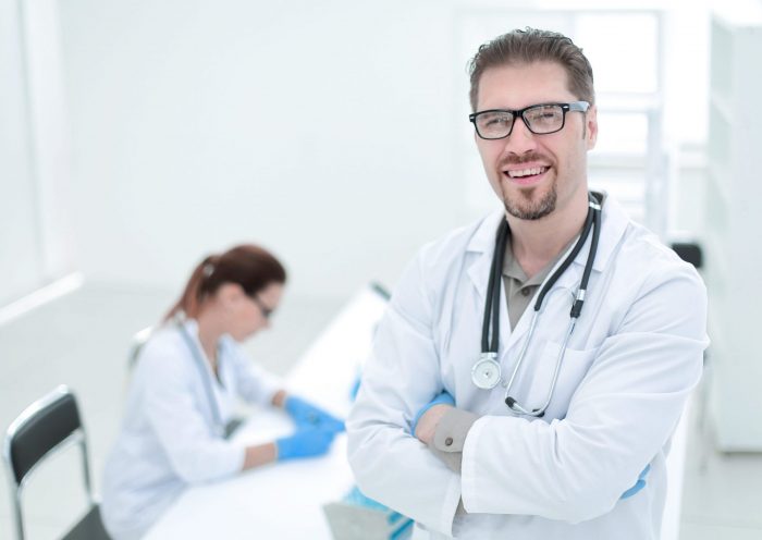Photo of smiling doctor illustrates blog: "What Is SBR in Medical Billing?"