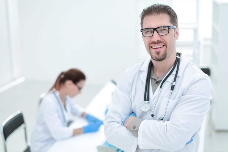 Photo of smiling doctor illustrates blog: "What Is SBR in Medical Billing?"