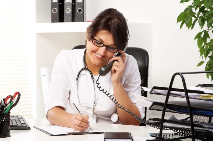 Female doctor on the phone illustrates blog "Medical Billing for Small Practices: 5 Reasons Why It Makes Sense"