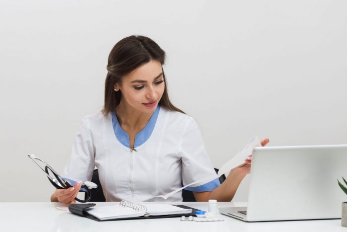 Photo of woman looking at documents illustrates blog "Can I Withdraw a request for Independent Bill Review (IBR)?"