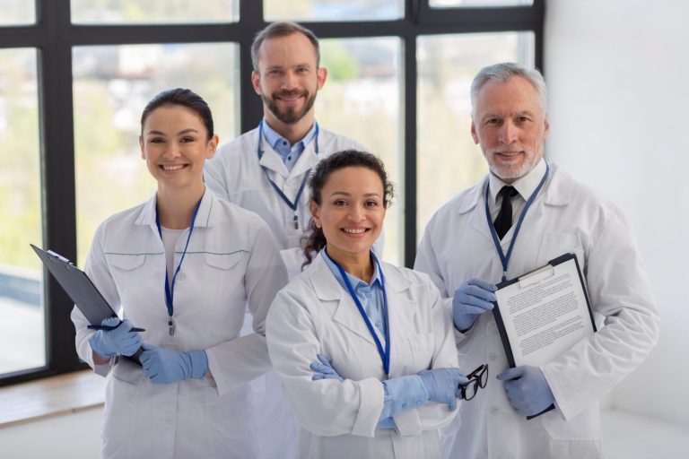 Team of healthcare professionals in lab coats illustrate blog "Here’s How Small Medical Practices Can Optimize their Revenue Cycle"