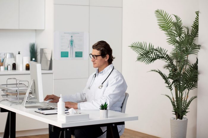Doctor sitting in office illustrate blog "5 Ideas to Improve the Efficiency of Your Practice"