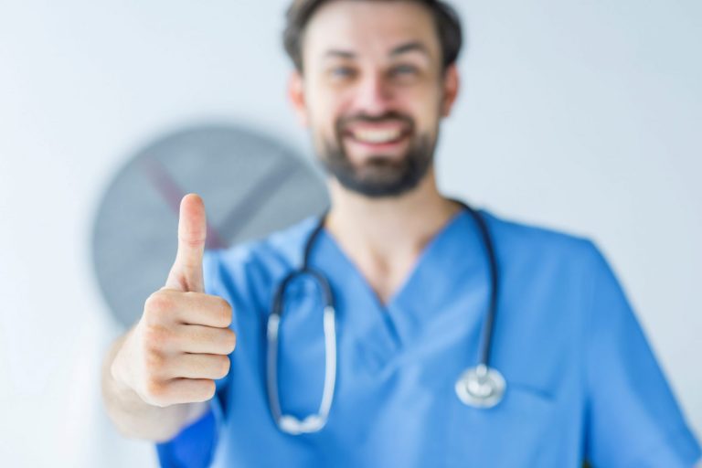 Healthcare professional giving the thumbs-up illustrate blog "5 Medical Billing Tips To Accelerate Your Practice’s Revenue Cycle"
