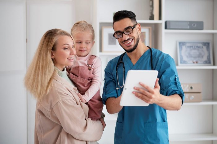 Young doctor talking to woman and child illustrates blog "4 Tips to Grow Your Medical Practice"