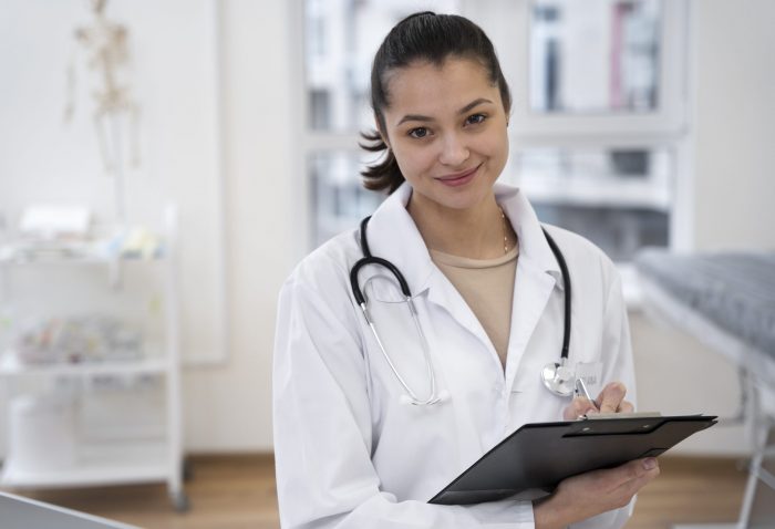 Woman in lab coat holding clipboard illustrates blog "Why Outsourced Medical Billing Services Make Sense for Small Practices"