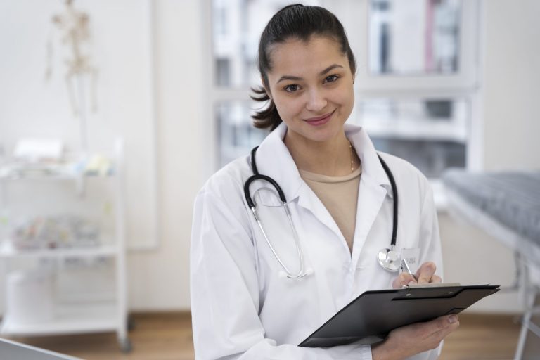 Woman in lab coat holding clipboard illustrates blog "Why Outsourced Medical Billing Services Make Sense for Small Practices"