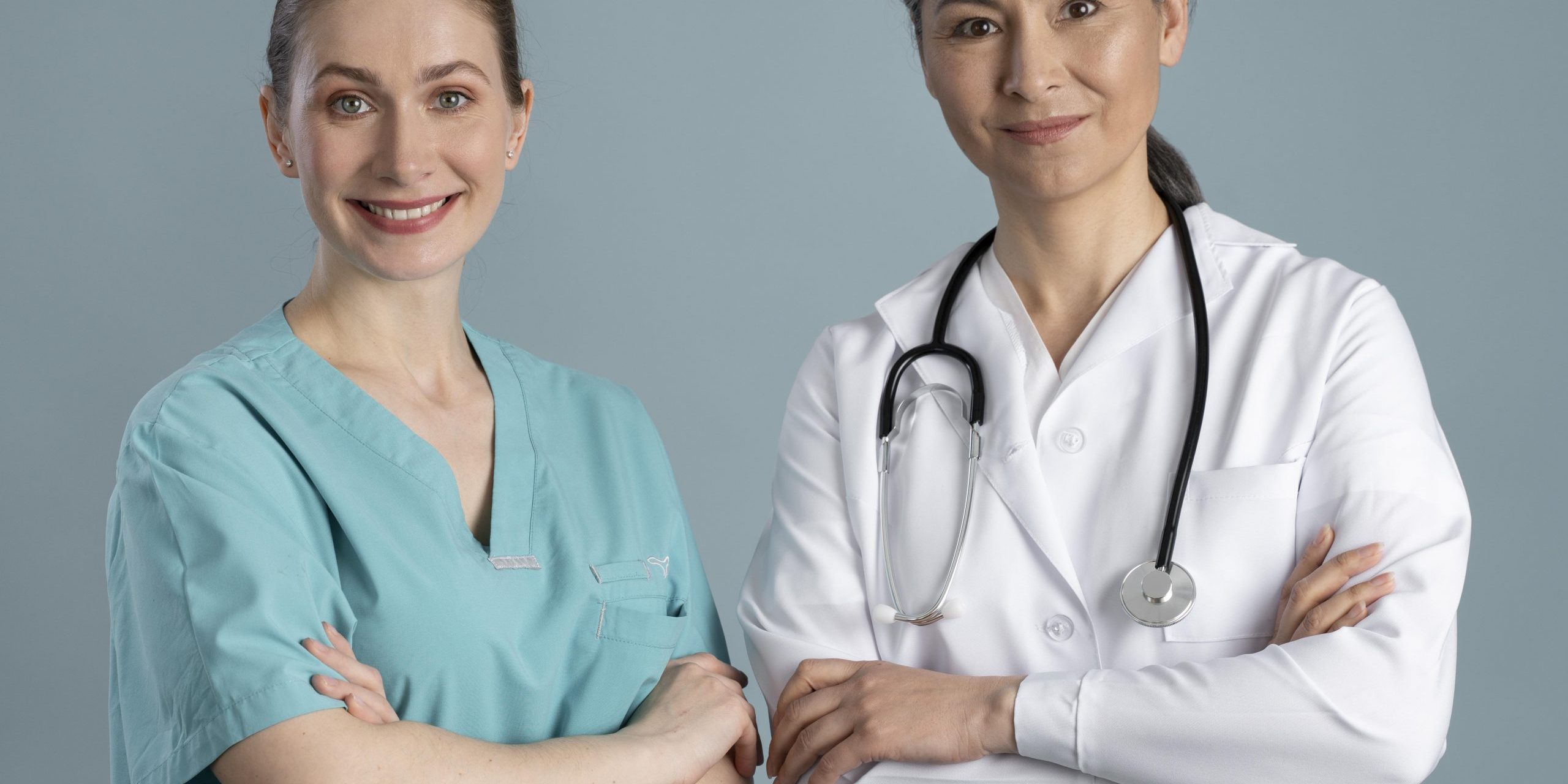 female-doctors-fp Two female doctors standing side by side illustrate blog "How Can QMEs Add Another Office Location?"