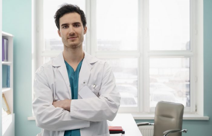 practiceiq2-fp Male doctor with crossed arms illustrates blog "5 Tips to Increase Revenue in Your Medical Practice"