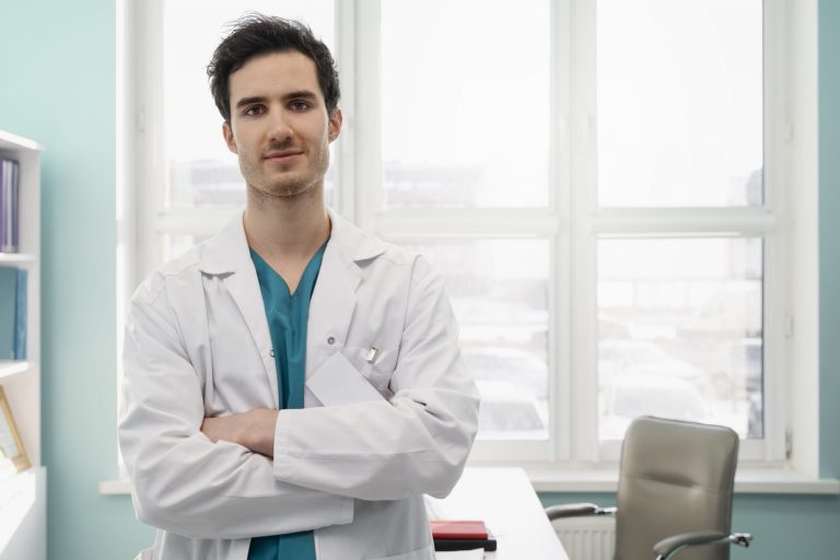 Male doctor with crossed arms illustrates blog "5 Tips to Increase Revenue in Your Medical Practice"