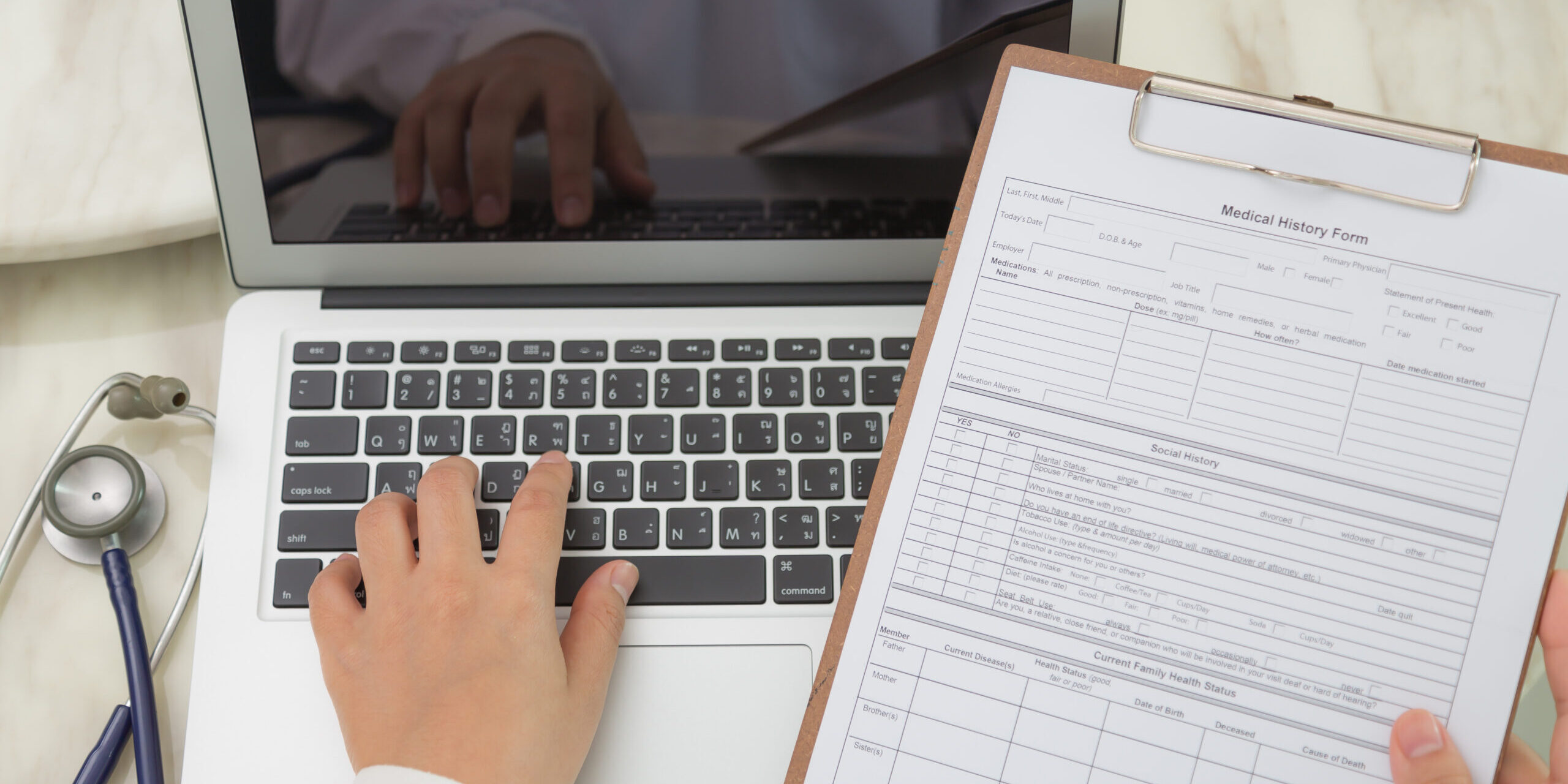 Doctor hands typing on laptop keyboard