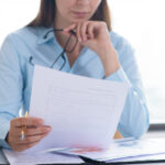 Healthcare administrator reviewing credentialing documents to prevent delays