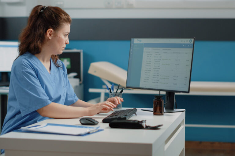 nurse-typing-computer-keyboard-consultation Digital mailroom management in a medical practice