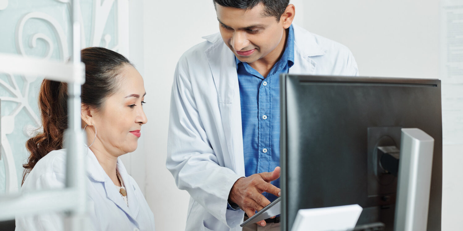 two-doctors-working-team-office ealthcare team reviewing automated scheduling system to reduce inefficiencies