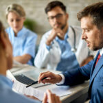 Medical staff reviewing billing claims to reduce medical claim rejections