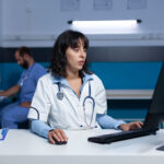 Healthcare staff managing medical admin workflows in a busy clinic office