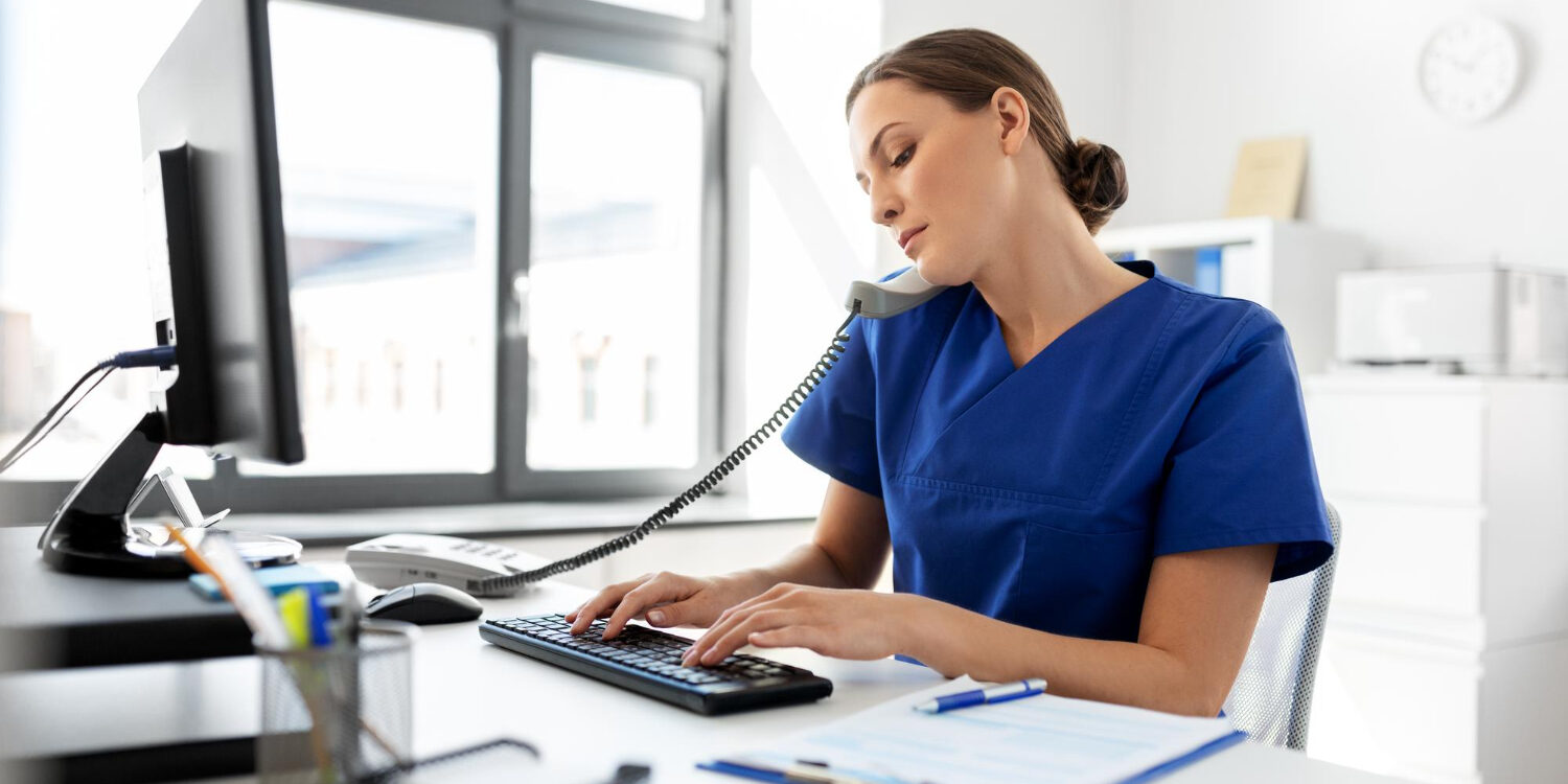 front desk staff performing insurance eligibility verification at clinic