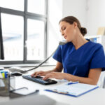 front desk staff performing insurance eligibility verification at clinic