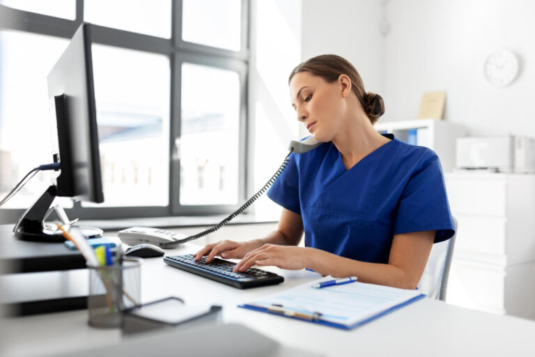 doctor-with-computer-calling-phone-hospital front desk staff performing insurance eligibility verification at clinic