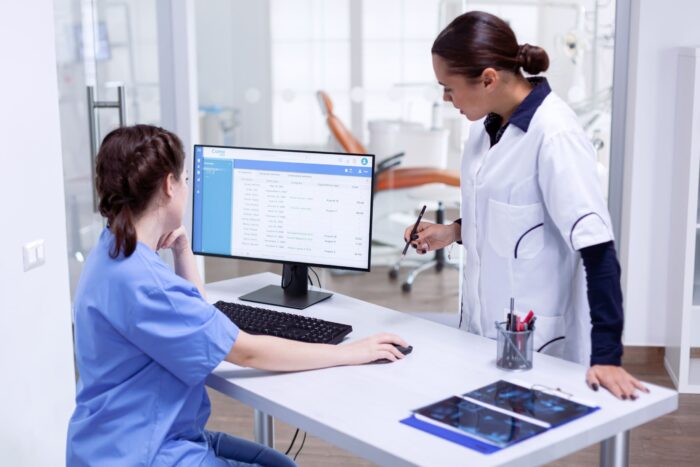 Healthcare staff performing an insurance verification audit at a medical office