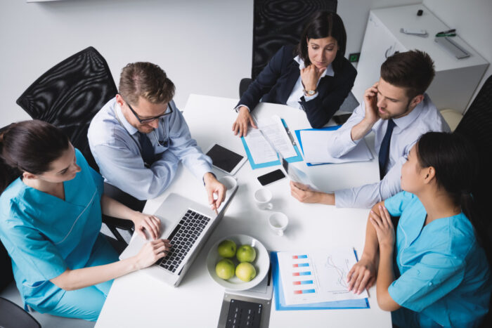 Healthcare team using administrative systems to support a growing medical group