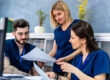 Administrative staff reviewing documentation risks tied to payer scrutiny and audit exposure