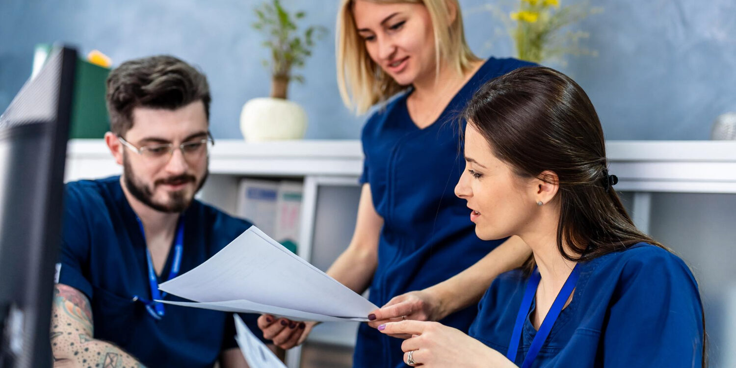 Administrative staff reviewing documentation risks tied to payer scrutiny and audit exposure