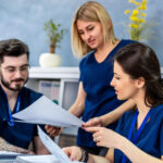 Administrative staff reviewing documentation risks tied to payer scrutiny and audit exposure