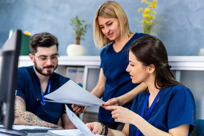 image-documentation-risks-payer-scrutiny Administrative staff reviewing documentation risks tied to payer scrutiny and audit exposure