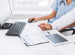 Healthcare staff performing eligibility verification before patient registration
